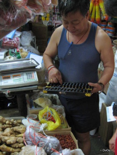 this shop owner uses digital scale and an abacus. :)