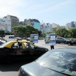 Two people holding commercial boards at the red light