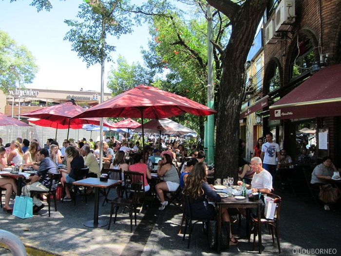 Outdoor cafe packed with tourists at a plaza